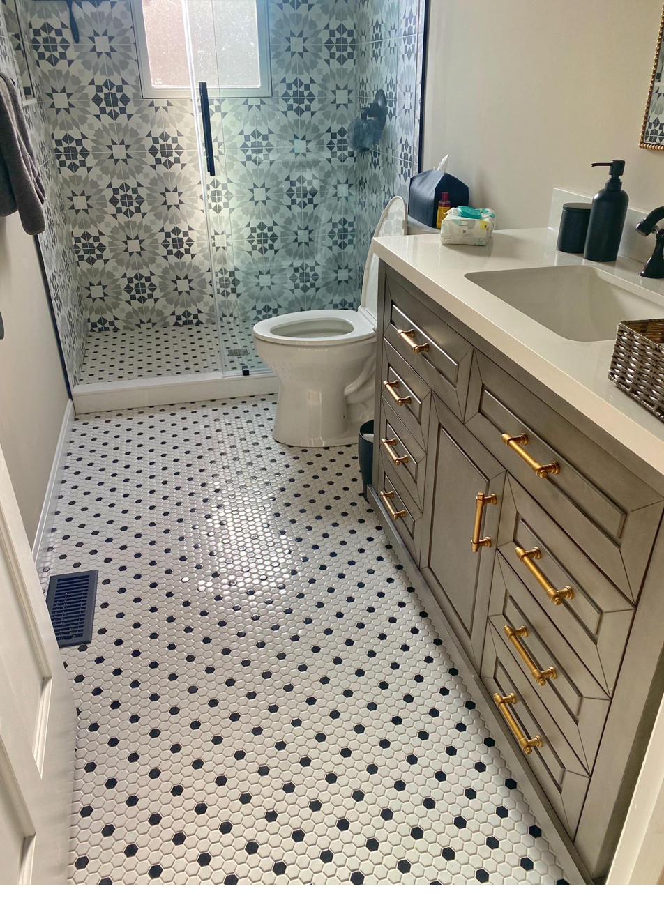 Narrow bath, gray vanity & mosaic floor, view 1 of 2