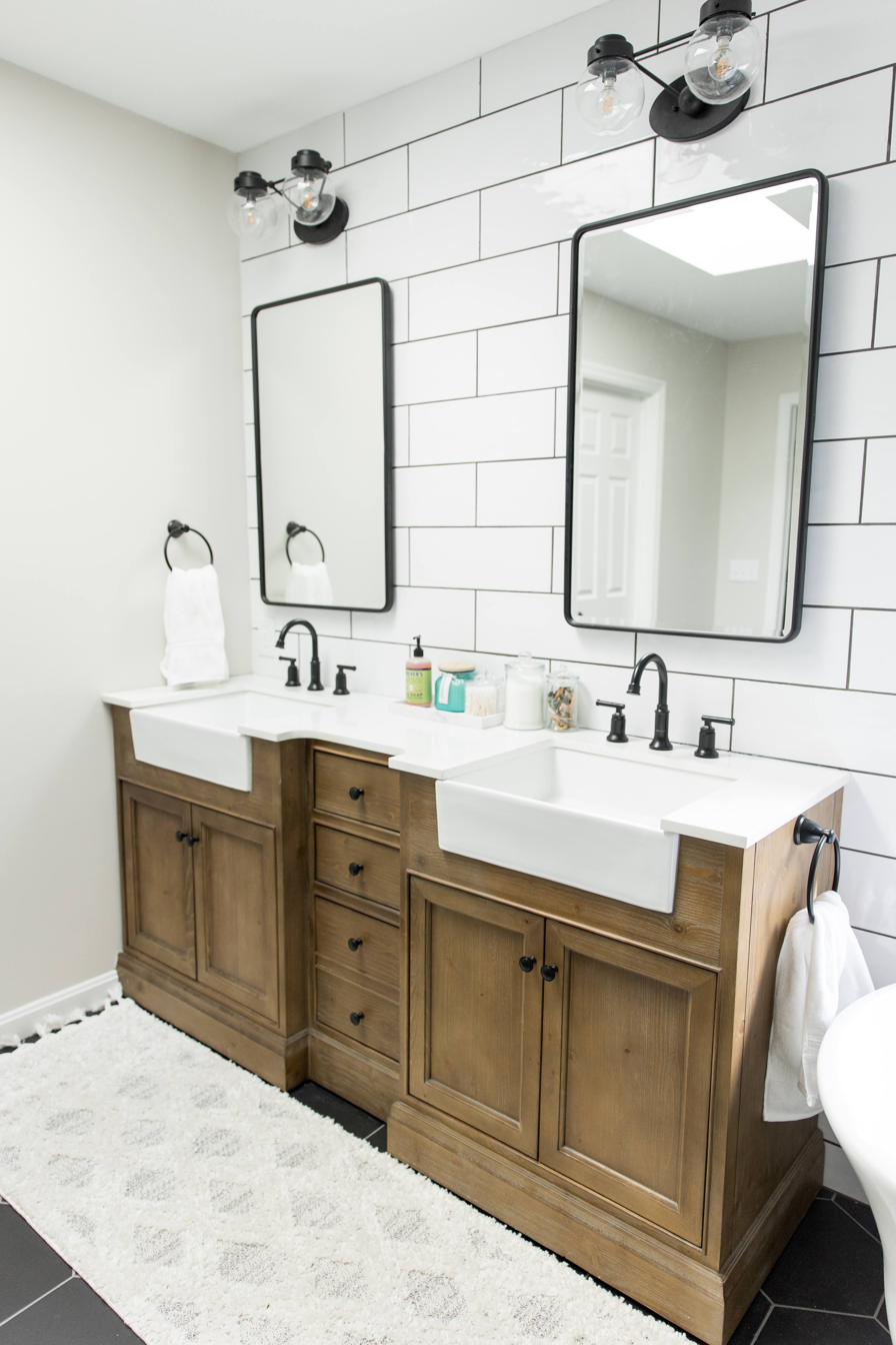 Wood vanity, subway tile & black hex master bath, view 1 of 9