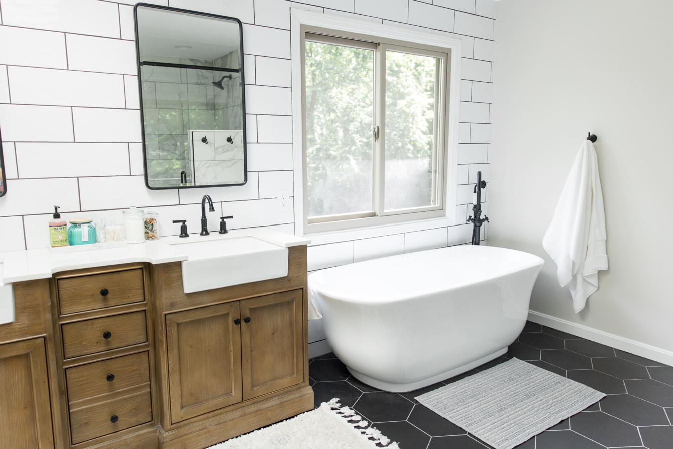 Wood vanity, subway tile & black hex master bath, view 2 of 9