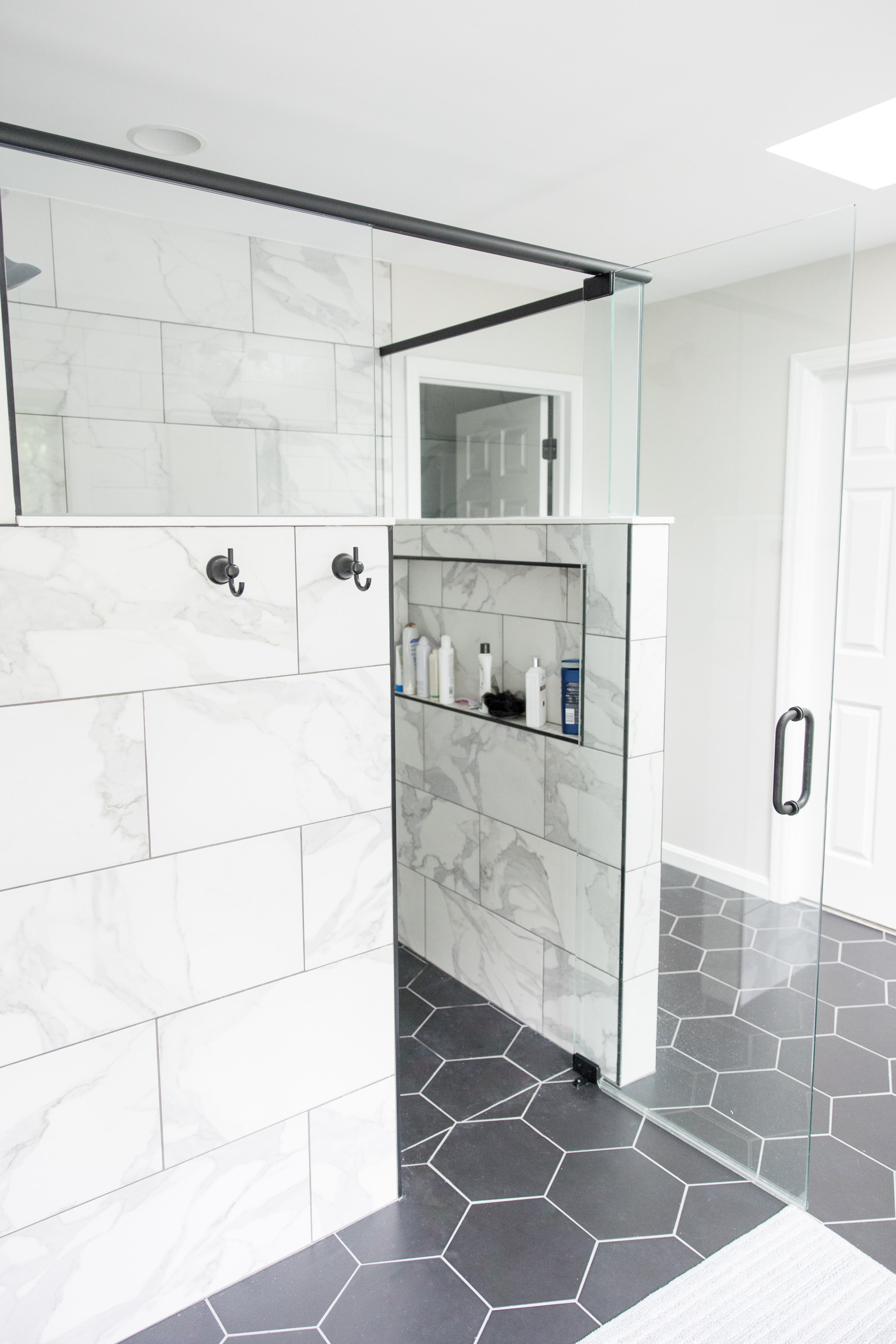 Wood vanity, subway tile & black hex master bath, view 6 of 9