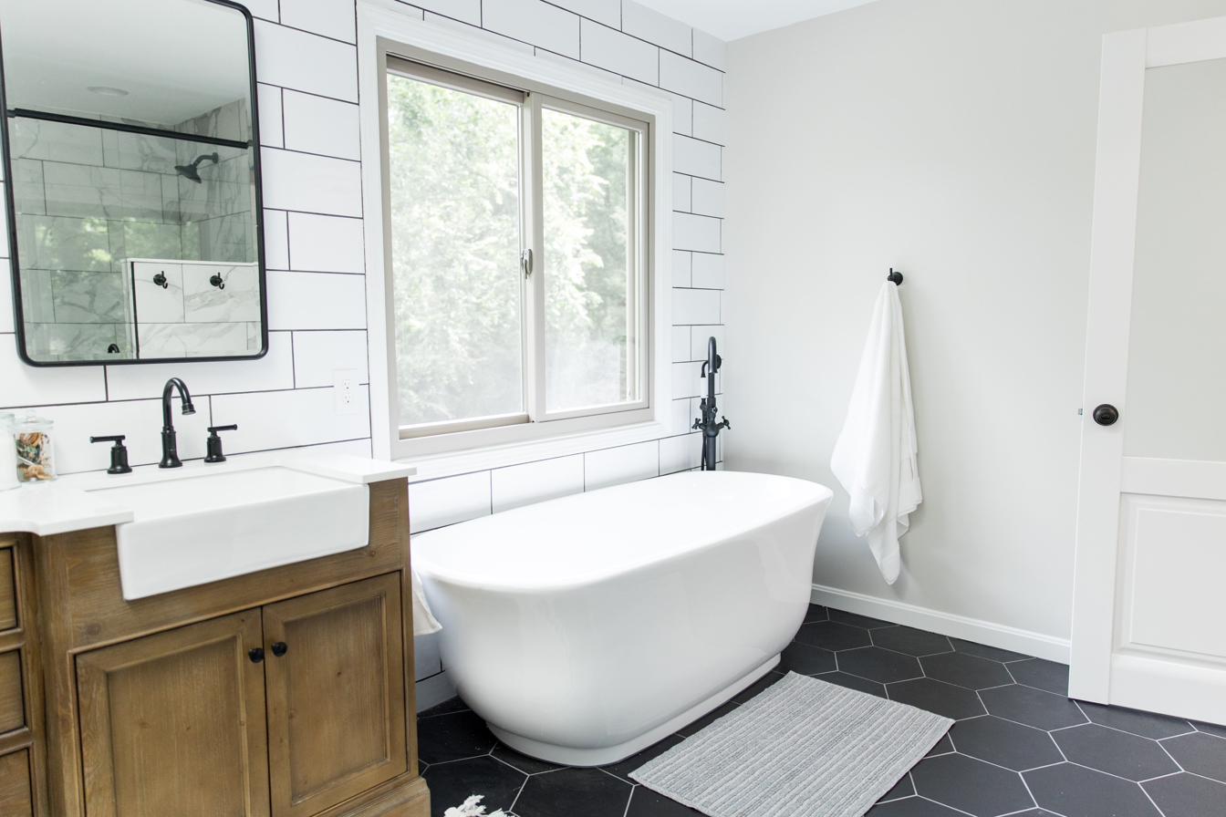 Wood vanity, subway tile & black hex master bath, view 8 of 9