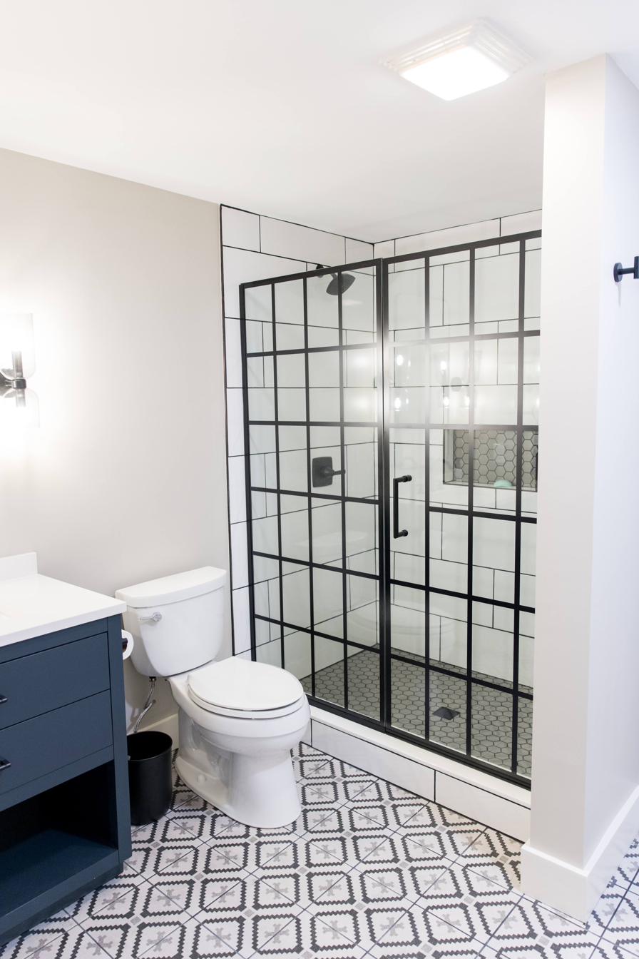 Basement bath, navy vanity & grid shower, view 1 of 2