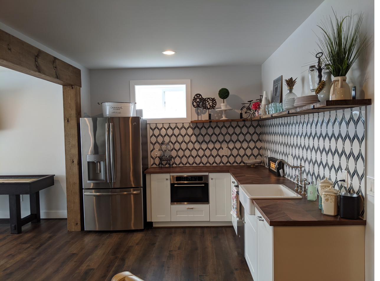Lower-level kitchen, patterned backsplash & walnut counters