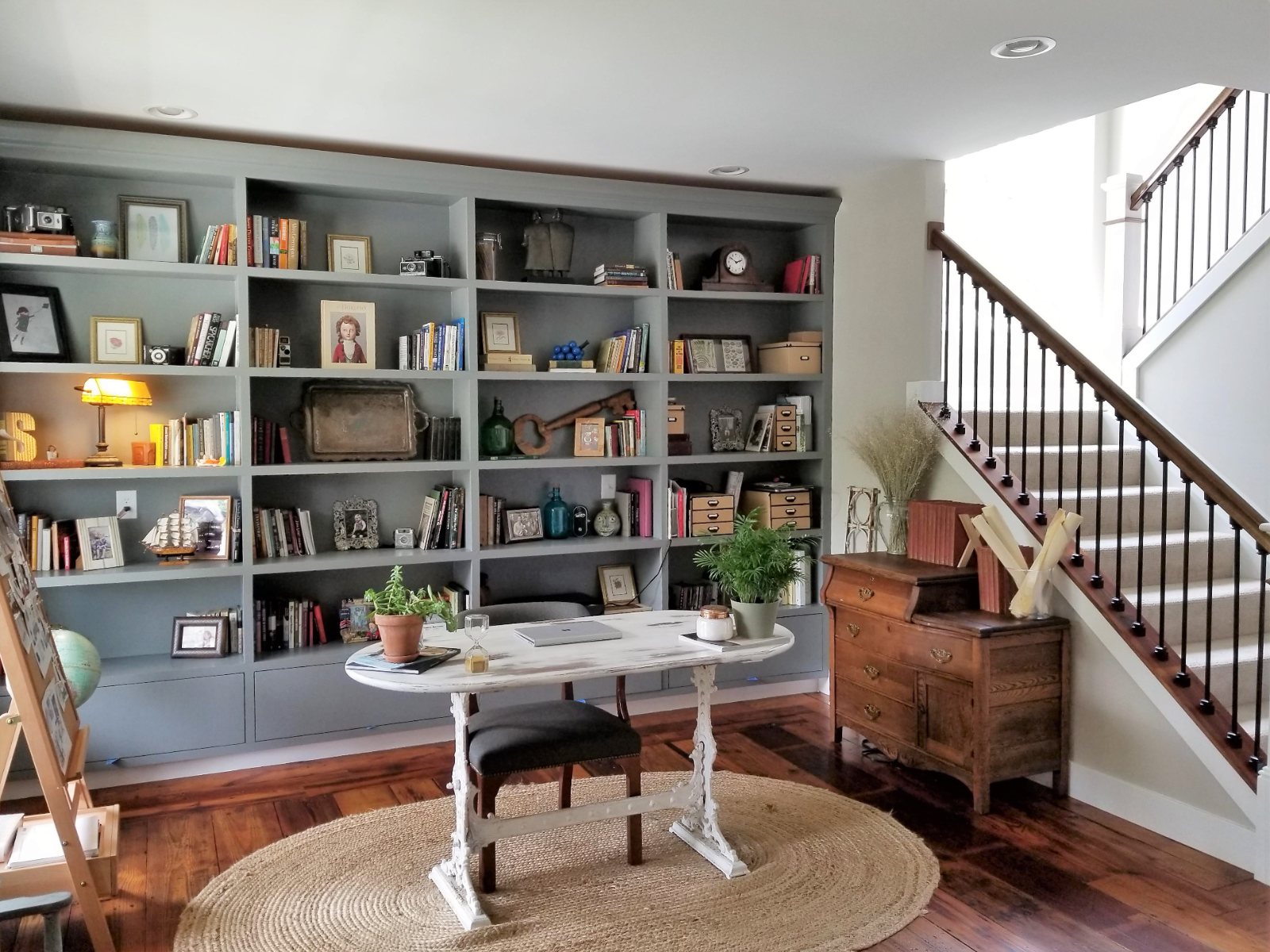 Maple Ave. library with floor-to-ceiling gray bookshelves and a writing desk